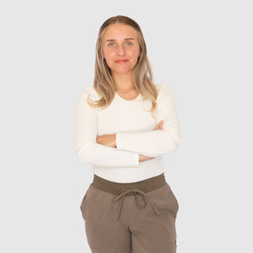 Nurse wearing a cream AeroKnit long-sleeve base layer top with brown scrub pants