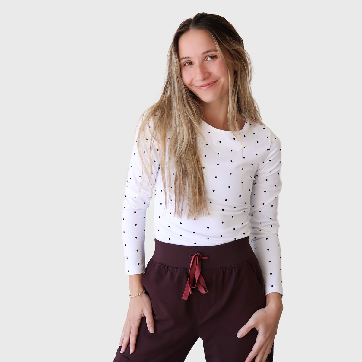 White PolkaDot FlexForm Compression Underscrub, front view, hands at the waistband