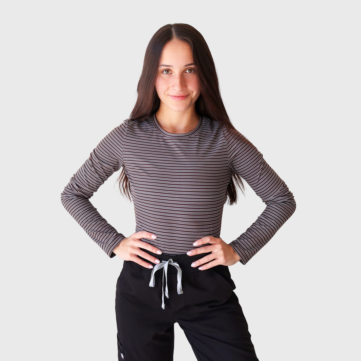 Fall Stripes CoreFit Underscrub, front view with hands on hips: long-sleeve top in fine taupe and black stripes